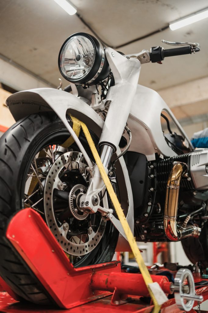 Custom motorcycle standing in repair shop